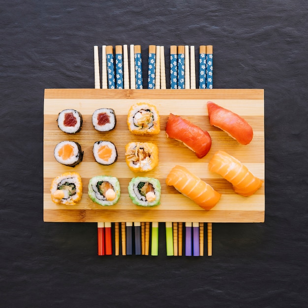 Free photo chopsticks under sushi