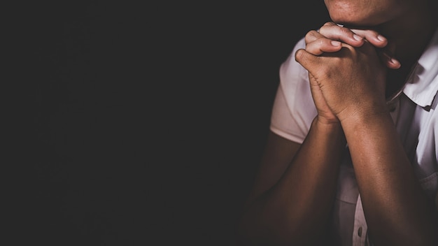 Christian life crisis prayer to god. Woman Pray for god blessing to wishing have a better life. woman hands praying to god with the bible. begging for forgiveness and believe in goodness.