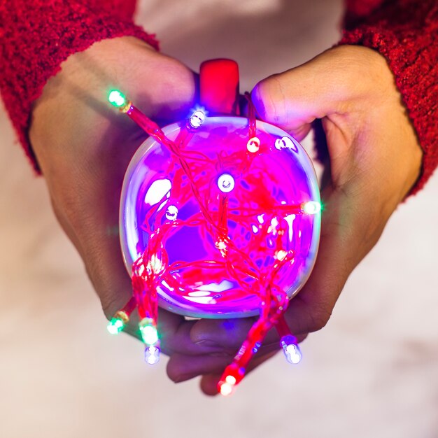 Christmas background with hands holding light object