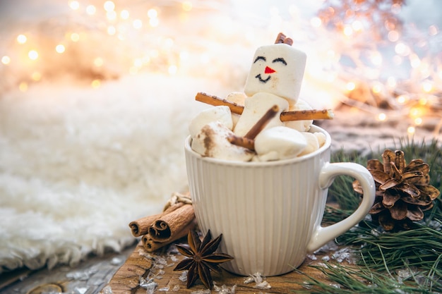 Free photo christmas background with marshmallow snowman in a cup