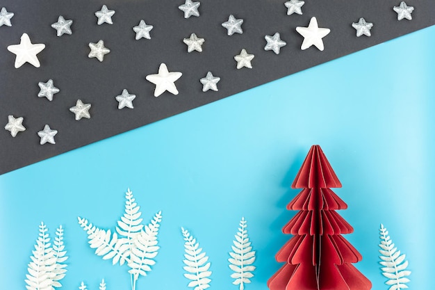 Free photo christmas background with origami paper tree on paper background flat lay