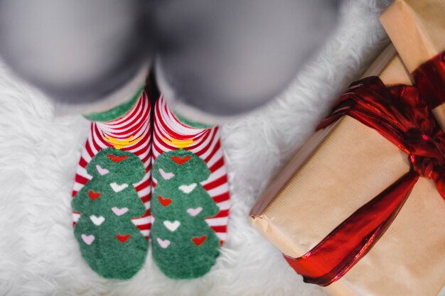 Christmas background with person wearing winter socks