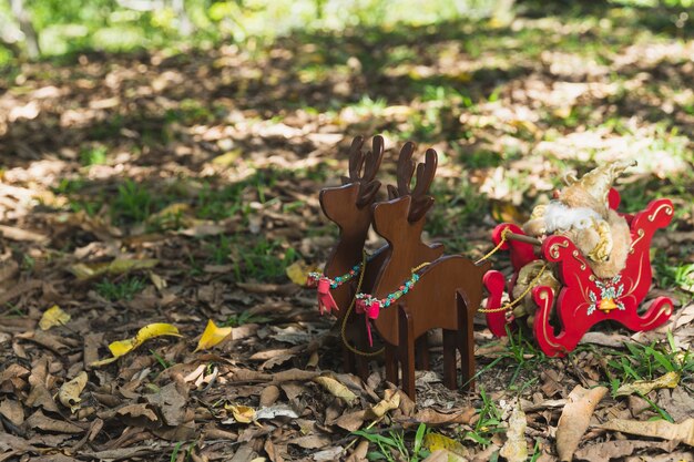 Christmas background with wooden reindeers in nature