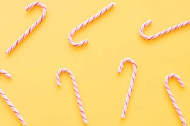 Christmas candy canes on yellow background