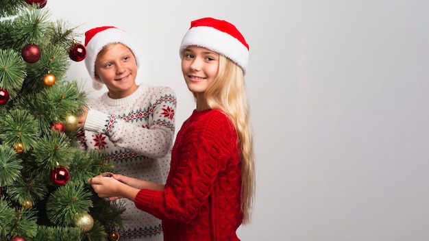 Christmas children decorating tree