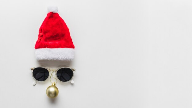 Christmas composition of face from hat and sunglasses