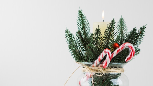 Free Photo christmas composition of fir branch and candle