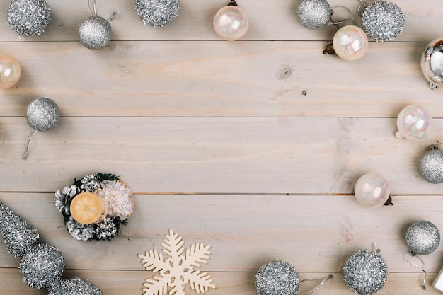 Christmas composition of silver baubles with candle