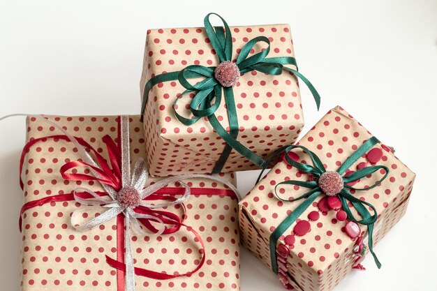 Christmas composition of various gift boxes wrapped in craft paper and decorated with satin ribbons. Top view, flat lay.