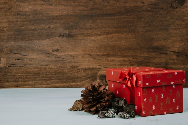 Christmas composition with present and pine cones