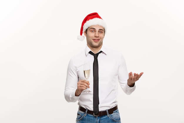 Free Photo christmas concept handsome business man celebrate merry christmas and happy new year wear santa hat with glass of champange