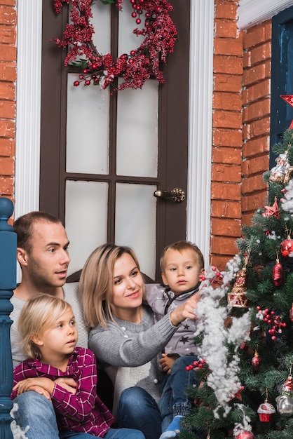 Christmas concept with family admiring christmas tree