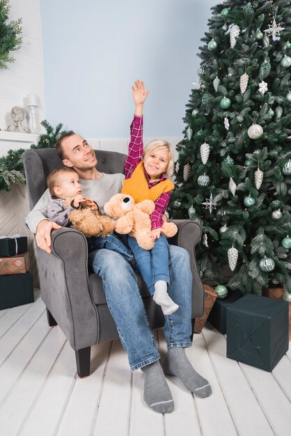 Christmas concept with father holding kids