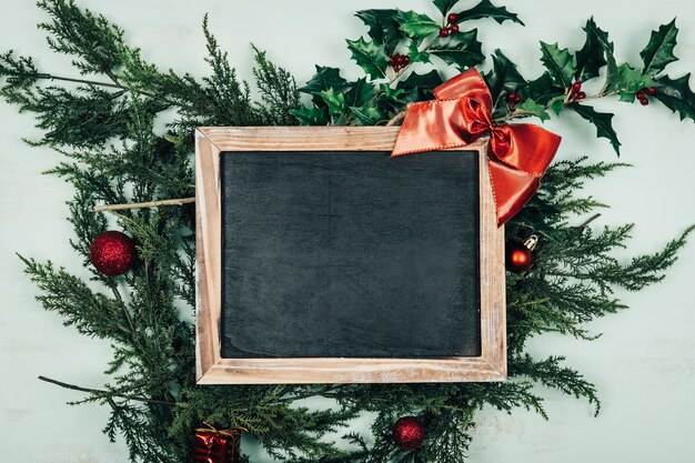 Christmas concept with slate on christmas leaves