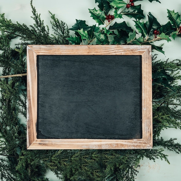 Christmas concept with slate on fir and mistletoe