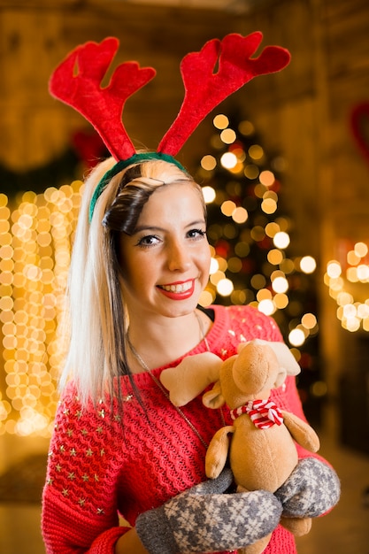 Free Photo christmas concept with smiling woman holding toy