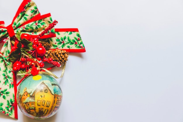 Christmas decoration baubles with holy berry; cone and ribbon on white background