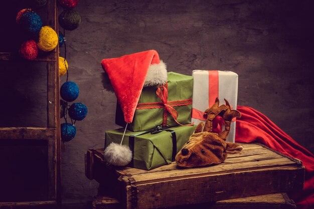 Christmas decoration with Santa's hat, glare balls and gift boxes.