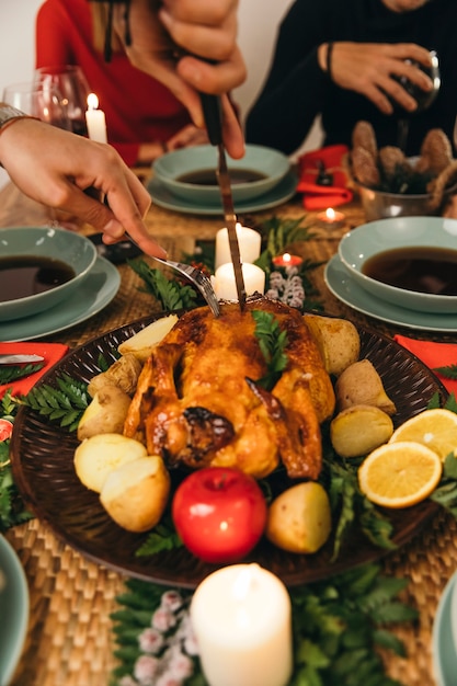 Free photo christmas dinner with knife cutting turkey