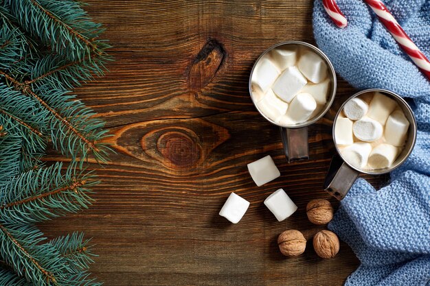 Christmas drink. Mug hot coffee with marshmallow, red candy cane on the wooden background. New Year. Holiday card. Rustic style. Top view and copy space.. New year 2018