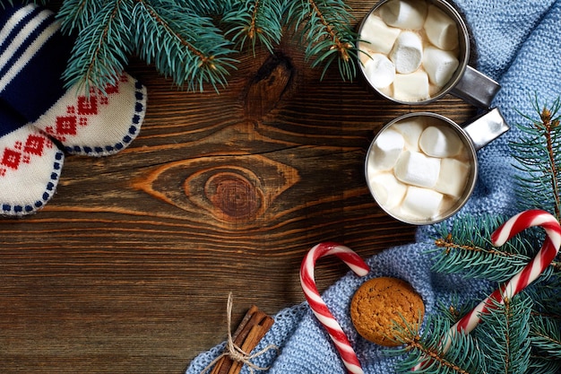 Christmas drink. Mug hot coffee with marshmallow, red candy cane on the wooden background. New Year. Holiday card. Rustic style. Top view and copy space.. New year 2018