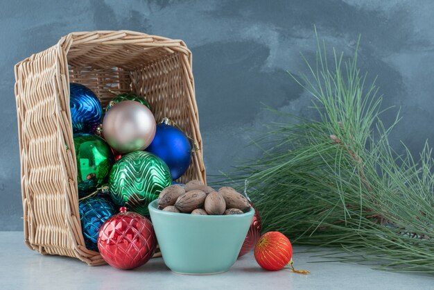 Christmas festive balls with a blue plate of nuts. High quality photo