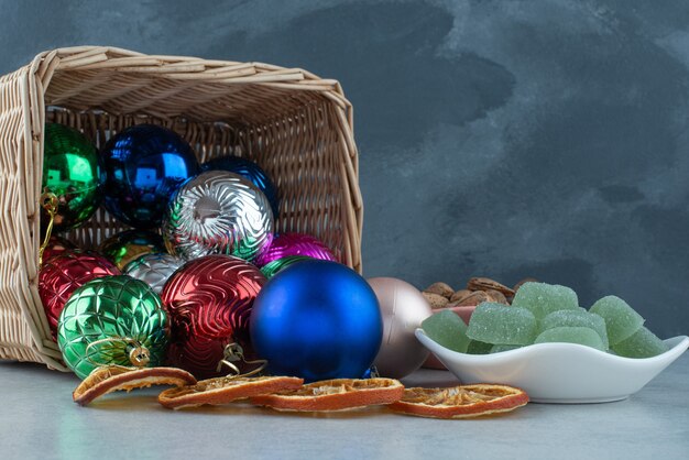 Christmas festive balls with white plate full of green marmalade . High quality photo