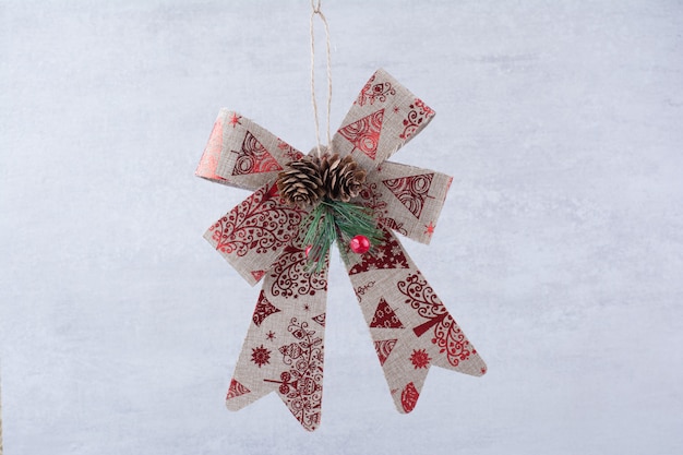 Christmas festive bow with pinecones on white background.