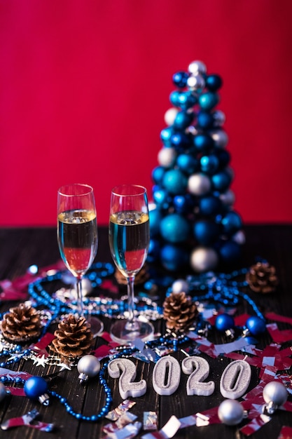 Christmas, festive mood: glass of champagne and New Year's 2020 decoration