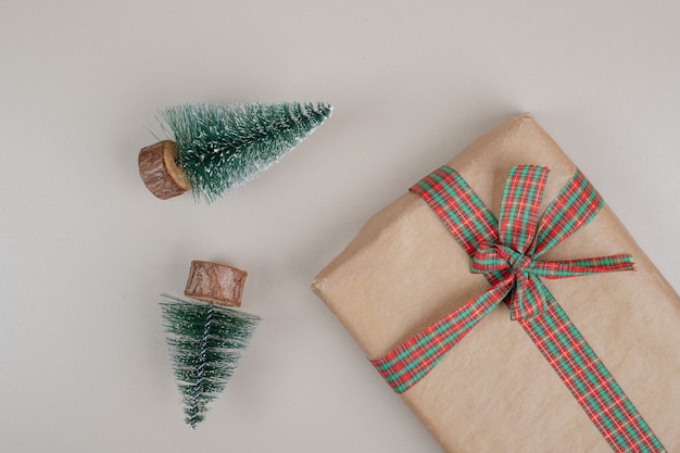 Christmas gift box wrapped in recycled paper with ribbon bow