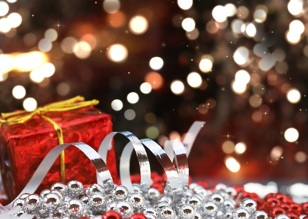 Free photo christmas gift and decorations on defocussed bokeh lights background