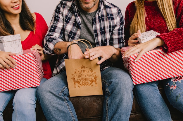 Free photo christmas gifting concept with man reaching in bag