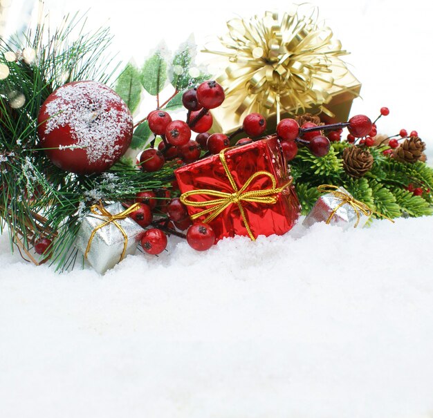 Christmas gifts and decorative objects nestled in snow