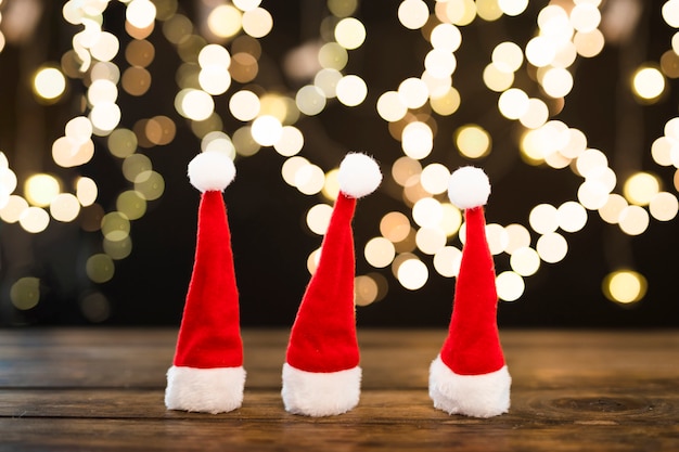 Free photo christmas hats near abstract lights