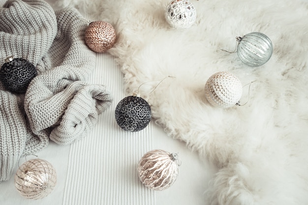 Christmas holiday still Life with decorative toys and knitted sweater.