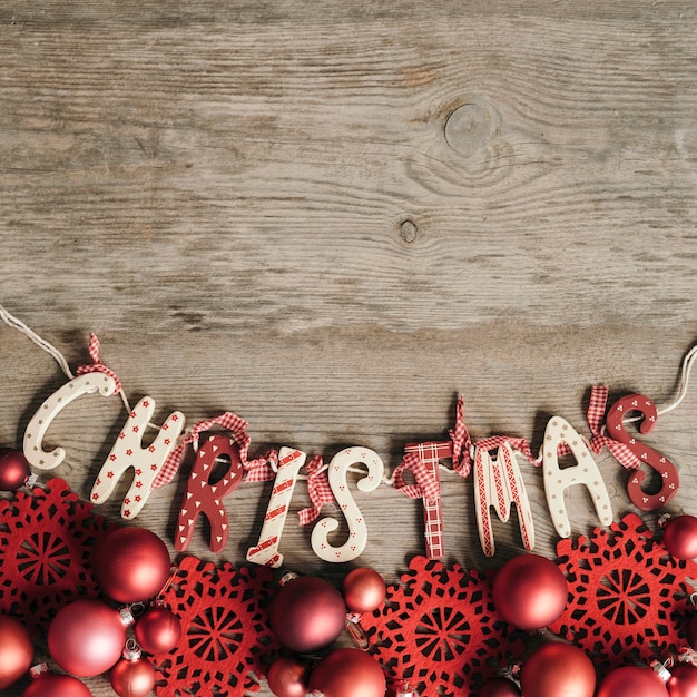 Free Photo christmas lettering with red ornament in vintage style