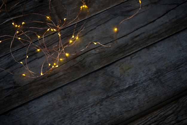 Free Photo christmas lights on a wooden table