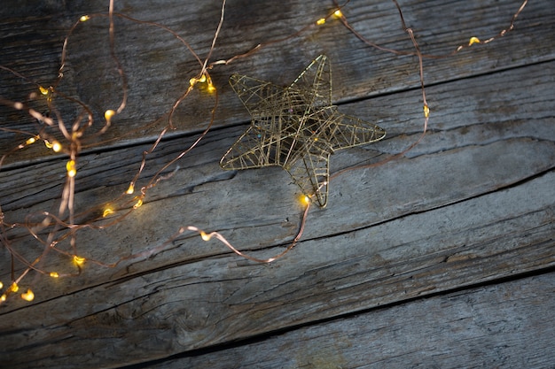 Free Photo christmas lights on a wooden table