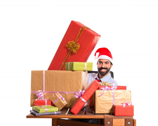 Christmas man in his office with several gifts