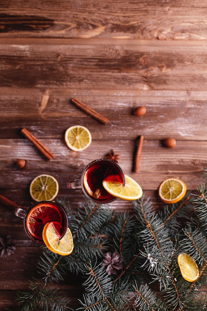 Free photo christmas and new year decor. two cups of mulled wine with oranges