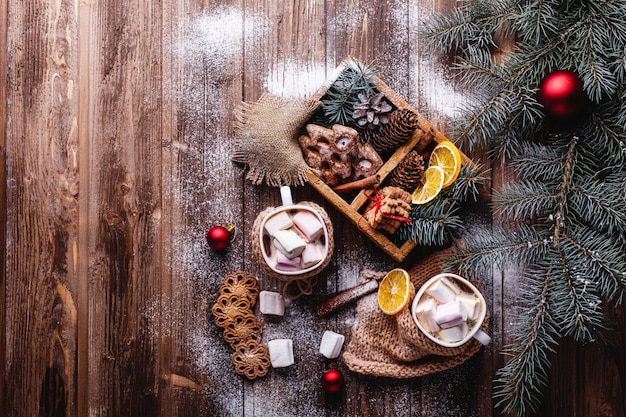 Christmas and New Year decor. two cups with hot chocolate, cinnamon cookies