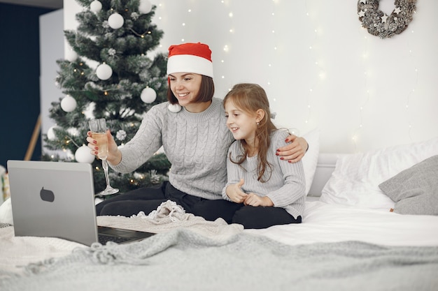 Christmas online. Celebration X-mas new year in lockdown coronavirus quarantine. Party online. Mother with daughter.