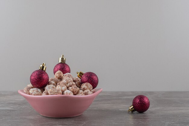 Christmas ornaments and confectionery on the marble surface