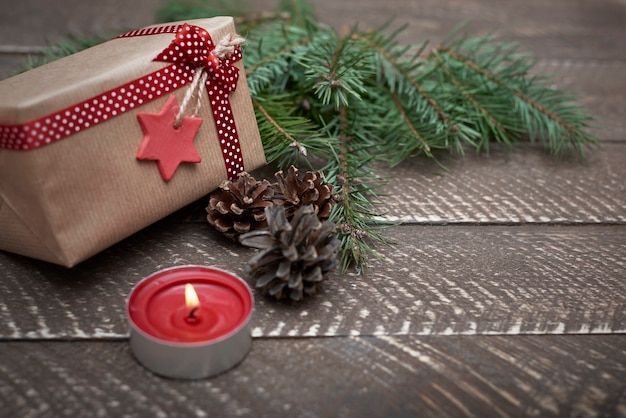 Christmas ornaments illuminated by the small candle