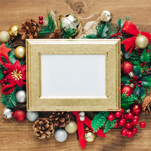 Free Photo christmas photo frame mock up template with decoration on wooden table.