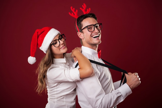 Christmas portrait of confident nerdy man with his girlfriend