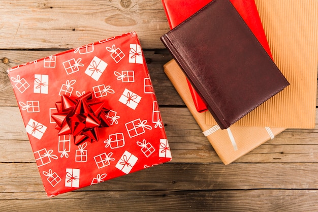 Christmas red gift box and leather notebook on table