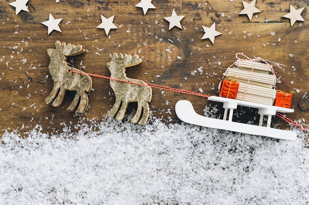 Free photo christmas snow decoration with reindeers and sled