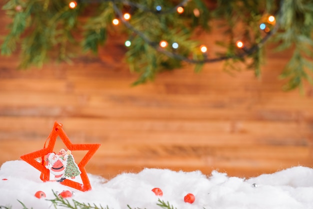 Christmas star decoration in snow with garland