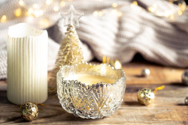 Christmas still life with candles and a knitted element on a blurred background